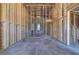 Unfinished basement featuring open framing and smooth concrete flooring, offering potential for expansion at 30 Grand Georgian Ne Ct, Cartersville, GA 30121