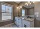 Bright bathroom with double vanity, granite countertops, framed mirror and white cabinets at 30 Grand Georgian Ne Ct, Cartersville, GA 30121