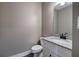 Powder room featuring granite countertop, modern faucet, toilet and framed mirror at 30 Grand Georgian Ne Ct, Cartersville, GA 30121