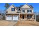 Charming two-story home with stone accents, a two-car garage, and a welcoming front porch at 30 Grand Georgian Ne Ct, Cartersville, GA 30121