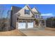Charming two-story home with stone accents, a two-car garage, and black window trim at 30 Grand Georgian Ne Ct, Cartersville, GA 30121
