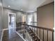 Hallway with wood-look floors, a staircase with iron railings, and multiple doorways at 30 Grand Georgian Ne Ct, Cartersville, GA 30121