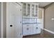 Kitchen space with white cabinetry, glass uppers, granite countertop and subway tile backsplash at 30 Grand Georgian Ne Ct, Cartersville, GA 30121
