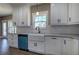 Bright kitchen featuring white cabinets, granite countertops, stainless steel appliances, and a farmhouse sink at 30 Grand Georgian Ne Ct, Cartersville, GA 30121