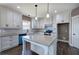 Bright and modern kitchen featuring white cabinets, granite countertops, a farmhouse sink, and stainless steel appliances at 30 Grand Georgian Ne Ct, Cartersville, GA 30121