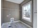 Neutral laundry room features a window for natural light and tile floors at 30 Grand Georgian Ne Ct, Cartersville, GA 30121