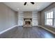 Living room with hardwood floors, a stone fireplace, and built-in bookshelves at 30 Grand Georgian Ne Ct, Cartersville, GA 30121