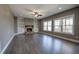 Living room with hardwood floors, a stone fireplace, and built-in bookshelves at 30 Grand Georgian Ne Ct, Cartersville, GA 30121