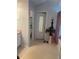 A full bathroom featuring neutral walls, vinyl flooring, and a door with mirror at 4237 Webb Meadows Dr, Loganville, GA 30052
