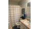 A clean bathroom featuring a striped shower curtain, toilet, sink, and decorative elements at 4237 Webb Meadows Dr, Loganville, GA 30052