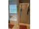 This bathroom includes shower with glass doors, and soaking tub underneath a window at 4237 Webb Meadows Dr, Loganville, GA 30052