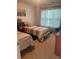 A bedroom with two twin beds, a window, and wood furniture at 4237 Webb Meadows Dr, Loganville, GA 30052