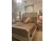 A well-lit bedroom featuring a neutral color palette and a large, upholstered headboard on the bed at 4237 Webb Meadows Dr, Loganville, GA 30052