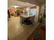 Open kitchen features wooden cabinets, tile floors, a dining table with four chairs, and a view to the living area at 4237 Webb Meadows Dr, Loganville, GA 30052