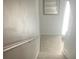 A carpeted staircase with a wooden handrail and a window at the top landing at 4237 Webb Meadows Dr, Loganville, GA 30052