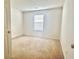 Bedroom with carpet, textured ceiling, and a window at 6214 Treeridge Nw Dr, Acworth, GA 30101