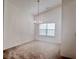 Dining room with neutral carpet, a chandelier, and a large window at 6214 Treeridge Nw Dr, Acworth, GA 30101