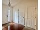 Welcoming entryway with hardwood floors, a glass-paned front door, and coat closet at 6214 Treeridge Nw Dr, Acworth, GA 30101
