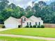 Charming single-story home with well-manicured lawn and attached two-car garage at 6214 Treeridge Nw Dr, Acworth, GA 30101