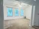 Cozy room featuring large windows, neutral walls, and ceiling fan at 6214 Treeridge Nw Dr, Acworth, GA 30101