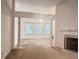 Open-concept living room with white columns, fireplace, and neutral carpet at 6214 Treeridge Nw Dr, Acworth, GA 30101