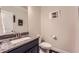 Half bathroom featuring a granite countertop, framed mirror, and decorative wall art at 2433 Santa Rosa St, Alpharetta, GA 30009
