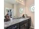 Bathroom vanity with granite countertops, stylish fixtures, and decorative accents at 2433 Santa Rosa St, Alpharetta, GA 30009
