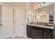 Well lit bathroom area featuring a granite countertop, double sinks, and a large mirror at 2433 Santa Rosa St, Alpharetta, GA 30009