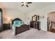 Bedroom with a ceiling fan, book shelf, queen bed, and ample closet space at 2433 Santa Rosa St, Alpharetta, GA 30009