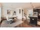 Cozy dining room area with hardwood floors, wainscotting, a modern chandelier, and seating for six at 2433 Santa Rosa St, Alpharetta, GA 30009
