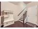 Entryway area with wooden floors, coat rack with bench, and staircase at 2433 Santa Rosa St, Alpharetta, GA 30009