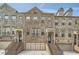 Charming townhome with brick exterior, two-car garage, and inviting entrance staircase at 2433 Santa Rosa St, Alpharetta, GA 30009