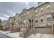 Attractive townhomes featuring brick and stone facades with attached garages and welcoming entryways at 2433 Santa Rosa St, Alpharetta, GA 30009