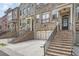 Townhome with stone and brick accents, an attached two-car garage, and brick staircase at 2433 Santa Rosa St, Alpharetta, GA 30009
