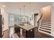 Bright kitchen features a granite island, stainless appliances, and dining area with lots of natural light at 2433 Santa Rosa St, Alpharetta, GA 30009