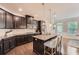 Modern kitchen with granite countertops, a central island, and stainless-steel appliances at 2433 Santa Rosa St, Alpharetta, GA 30009
