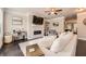 Bright and airy living room with a fireplace, television, and comfortable seating arrangement at 2433 Santa Rosa St, Alpharetta, GA 30009