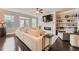 Bright living room with a white sofa, fireplace and modern ceiling fan at 2433 Santa Rosa St, Alpharetta, GA 30009