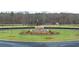 Well-manicured roundabout features mature plants and trees with a water feature at 356 Sound Cir, Stockbridge, GA 30281
