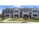 Charming townhome exterior with manicured lawn, black shutters, and coordinated paint scheme at 356 Sound Cir, Stockbridge, GA 30281