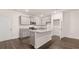 Modern kitchen boasts gray cabinets, stainless steel appliances, granite countertops, and a functional island at 356 Sound Cir, Stockbridge, GA 30281