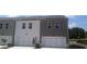 Modern townhomes with white garage doors and large windows, perfect for a growing Gathering at 356 Sound Cir, Stockbridge, GA 30281