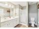 Bathroom with a double vanity, a walk-in shower, and a toilet at 3709 Mcguire Nw St, Kennesaw, GA 30144