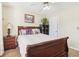 Bedroom with carpet and a dark wood bed frame, plus a matching nightstand and bookcase at 3709 Mcguire Nw St, Kennesaw, GA 30144