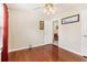 Bedroom features hardwood flooring, neutral walls, a ceiling fan, and a view into an adjacent room at 3709 Mcguire Nw St, Kennesaw, GA 30144