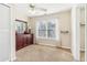 Bright bedroom features neutral carpet, a large window with sheer curtains, and a dark wood dresser with a mirror at 3709 Mcguire Nw St, Kennesaw, GA 30144