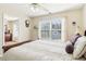Bedroom showing queen size bed and view to dresser, ceiling fan and wooded area from window at 3709 Mcguire Nw St, Kennesaw, GA 30144