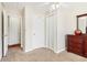 Bedroom with neutral carpet features white doors and trim, plus a dark wood dresser with decorative accessories at 3709 Mcguire Nw St, Kennesaw, GA 30144