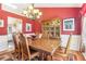 Formal dining room featuring a wooden table and chairs and a decorative chandelier over a colorful rug at 3709 Mcguire Nw St, Kennesaw, GA 30144