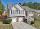 Inviting two-story home with a brick-accented facade, two-car garage, and well-manicured lawn at 3709 Mcguire Nw St, Kennesaw, GA 30144